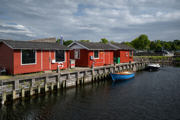 Small Boat Rests Beside Red