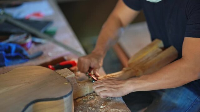 Skilled artisan working on a wooden craft project, shaping and carving wood, surrounded by tools and sawdust in a creative workshop environment