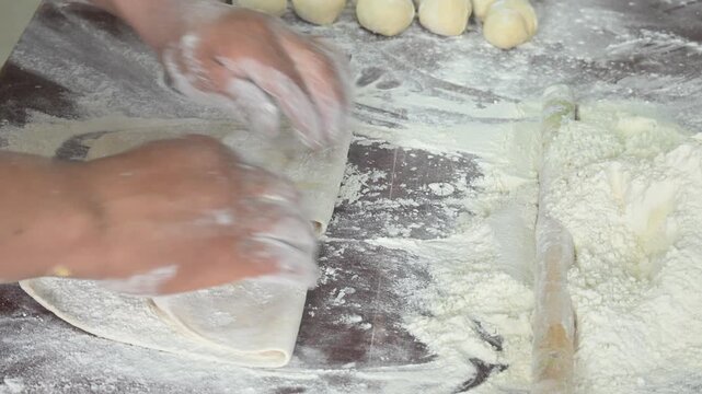 STRETCHING THE SWEET BREAD DOUGH WITH FLOUR