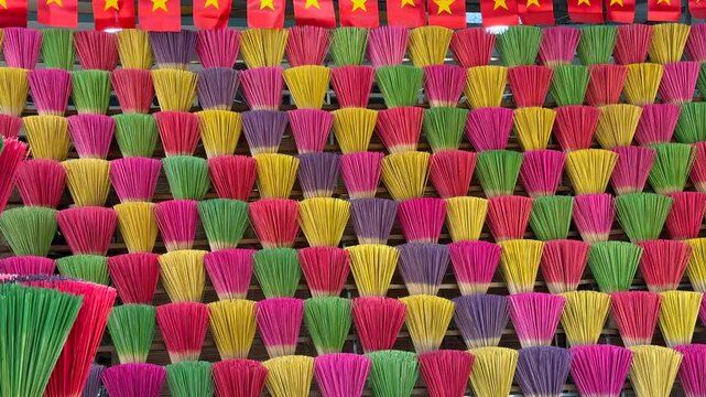 Colorful incense sticks arranged in rows at local Vietnamese market, reflecting traditional craftsmanship, daily life, and cultural rituals in Vietnam.