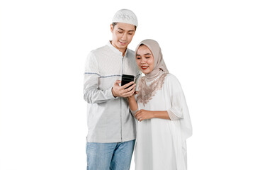 Muslim Couple Looking at Smartphone Together on White Background