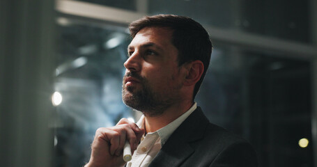 Night, thinking and man in office with business plan, project and brainstorming ideas at digital...