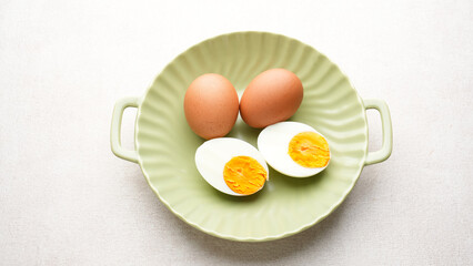 Hard boiled eggs peeled and cut in plate