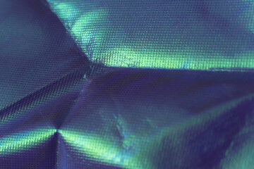 Iridescent metallic foil texture with angular folds