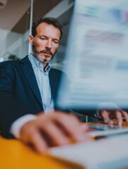 Fototapeta premium Mature Businessman Using ERP Software System on Virtual Interface for Data Management and Business Process Integration in a Modern Digital Office Setting