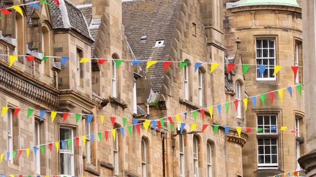 Colorful Festival Bunting Hanging Across Historic Stone Building Facades