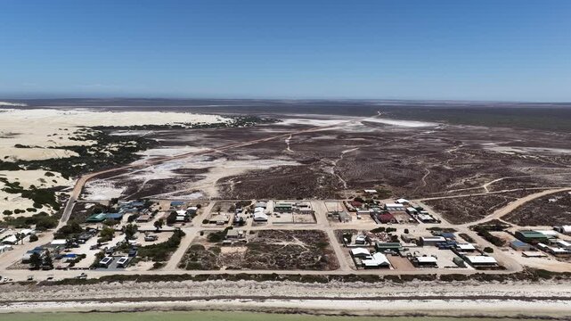 Scott Bay, Fowlers Bay, South Australia &ndash; 4K aerial drone view of Great Australian Bight coastline, turquoise ocean, sand dunes, Caravan Park, beach and limestone cliffs