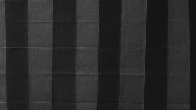 Black Paper Folded into Vertical Accordion Pleats image