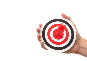 Hand holding a target with a red dart hitting the bullseye, representing goal achievement, accuracy, focus, success strategy, precision planning, motivation, performance tracking, and reaching object
