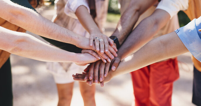 Outdoor, friends and hands stack for hiking, teamwork or motivation for trekking adventure together. Group activity, collaboration or people with huddle for bonding, support or solidarity for fitness