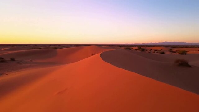 Minimalist Arid Beauty Highlight the stark, clean lines and subtle textures of sand dunes and sparse vegetation against a vast, uncluttered sky.