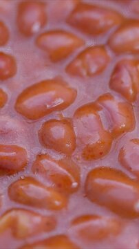 Stewed bean presentation, Juicy red beans in flavorful sauce, Close shot of beans in savory tomato glaze, Brightly glazed baked beans immersed in rich tomato sauce for display