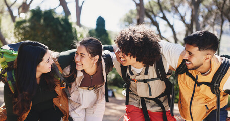 Fototapeta premium Smile, people and hug for hiking outdoor for fitness, adventure and bonding on holiday. Happy, friends and embrace for backpacking getaway, trekking reunion and group support for vacation in forest