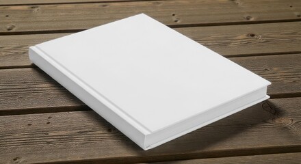 Fototapeta premium A closed blank white book lying on a wooden surface with a brown color