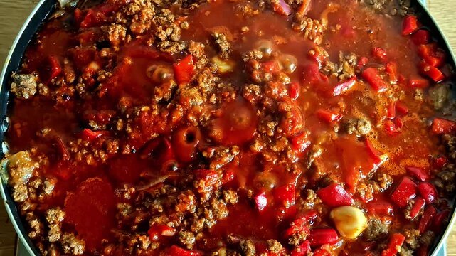 Hearty beef stew with red peppers simmering, captured in Jelgava, Latvia