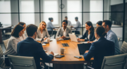 Fototapeta premium Blurred diverse group of business professionals having a meeting around a conference table in a modern office setting, focused discussion and teamwork concept
