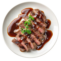 Sliced steak topped with dark sauce and herbs on a white plate, top view