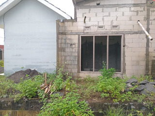 Unfinished House with Overgrown Vegetation