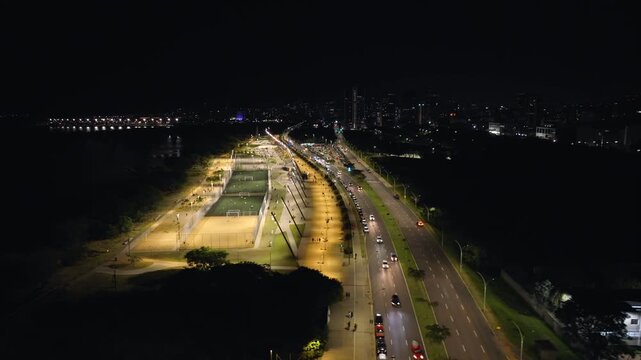 Cinematic night aerial sideways parallax view of Orla do Guaiba Sports Park in Porto Alegre, Brazil. 4K 10-bit ProRes drone footage.