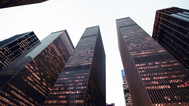 Slow motion of Manhattan skyscrapers, panoramic skyward view from the street in slow motion, New York City, USA