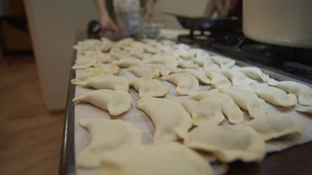 Traditional pierogi cooking process with handmade dumplings