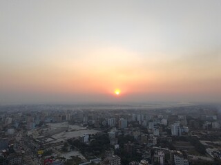 Obraz premium Sunset Drone Shot of City Skyline with Urban Architecture
