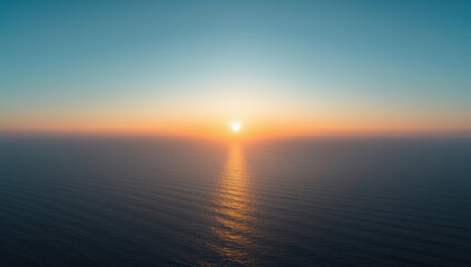 Serene sunset over calm ocean with golden reflection on water