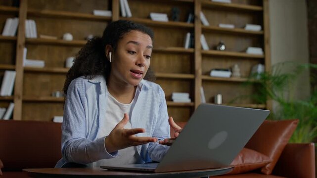 Young woman talking seriously during video call