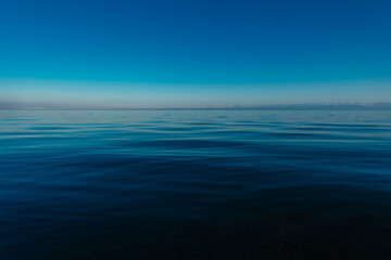 Calm sea with mountains and clear sky