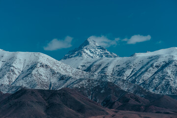 Snow-covered mountain peak in clouds, Kyrgyzstan
