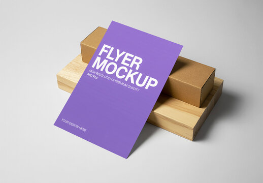 Vertical Flyer Mockup Leaning on Stacked Wood Block