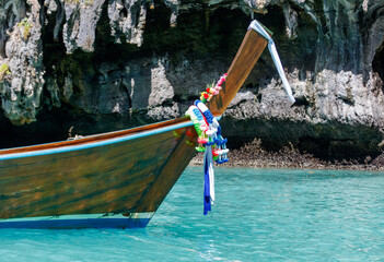 A boat with a blue and white stripe is floating in the water