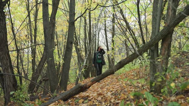 Female musician portrait, Leatherclad woman in woods, Closeup of woman with layered clothing in forest setting, Cinematic portrait of woman with leather jacket among colorful autumn leaves