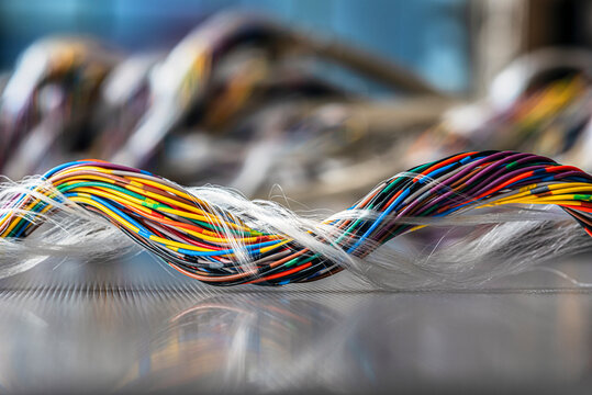 Close-up of bundled multicolored twisted pair cables used in telecommunication and computer networking systems, illustrating wired data transmission and modern IT infrastructure.
