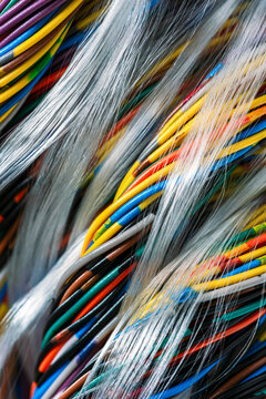 Close-up of bundled multicolored twisted pair cables used in telecommunication and computer networking systems, illustrating wired data transmission and modern IT infrastructure.