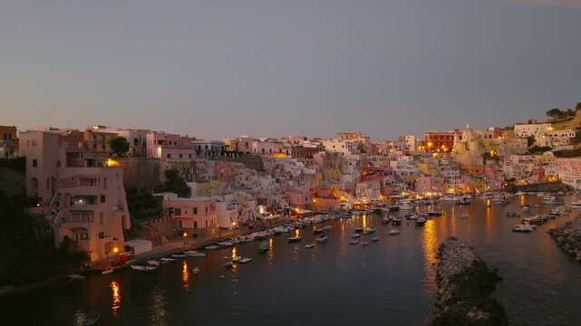 Dusk At Marina di Corricella - Historic Fishing Village On Island Of Procida In Italy. wide aerial shot