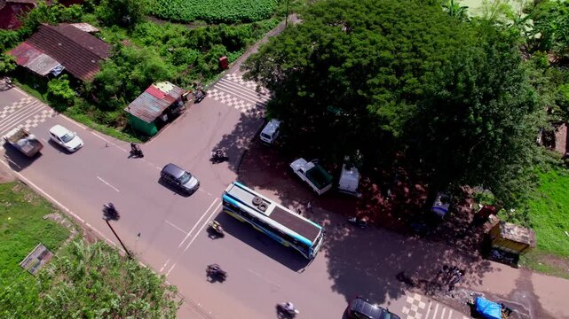 bus stopped in Local bus stop on rural area at madgaon, goa, india. day time, zib shot, drone shot, 4k.