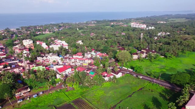Aerial view of coastal village with farming land and Arabian Sea at colva, goa, india. day time, push in shot, semi circle shot, drone shot, 4k.