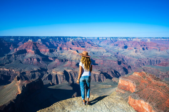 Young woman enjoying majestic views of Grand Canyon vis