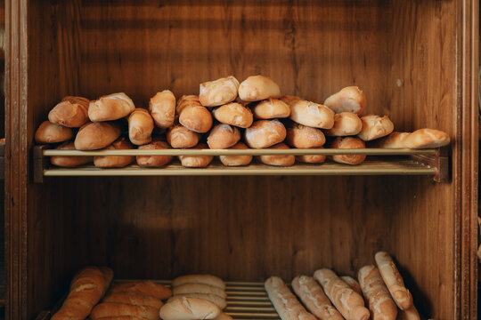 Freshly baked bread loaves filling wooden display shelves