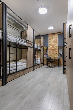 Loft hostel dormitory with industrial elements and wooden bunk beds