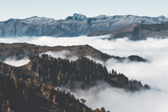 panorama in the mountain with low fog and clouds, forest, autumn time and wide point of view