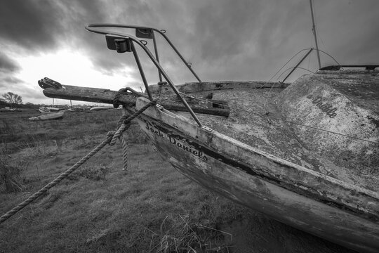 Derelict Abandoned Boat in Black & White at Heswall, Wirral UK &ndash; Weathered Maritime Decay on Shoreline