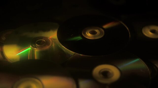 Vibrant light reflections on cds showcasing dynamic color transitions