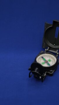 Movement of the arrow in the military compass. Blue background. Abstract Politics, Economy, and Business. Shallow Depth of Field. 