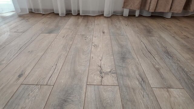 New laminate flooring. Laminated parquet with brown wooden texture