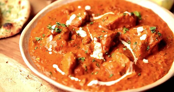 Authentic butter chicken paired with soft garlic naan bread for a complete Indian meal. Tender butter chicken with smooth gravy make it ideal for lunch and dinner serving in restaurant