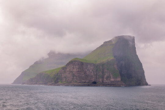 Rugged misty basalt cliffs of N�lsoy in the Faroe Islands