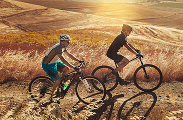 Obraz premium Fitness, cycling or people on dirt road with bike, endurance training or support in cardio workout. Path, team or cyclist with bicycle, physical activity or sports goal in outdoor challenge.