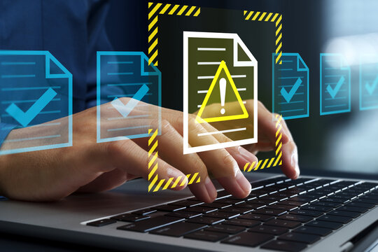 Problematic document and reject file. Error notification on approval system. Businessman using laptop computer to submit documents to compliance verification system.